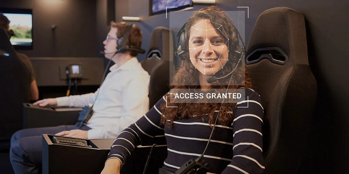 Woman wearing a headset with biometric tech overlay on her face and the text 'access granted' below